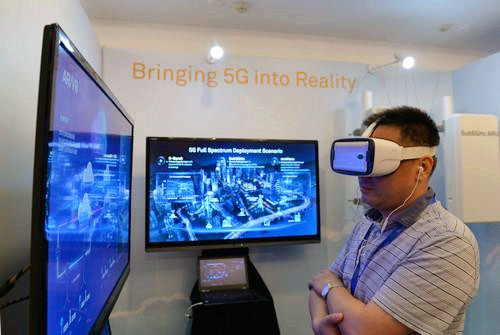 嘉賓在峰會現(xiàn)場利用VR設(shè)備觀看5G測試外場。